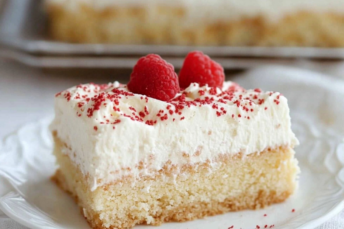 Tres leches cake with whipped cream and strawberries on a plate, showcasing a popular Mexican dessert recipe