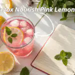 A glass of detox nourish pink lemonade with fresh ingredients