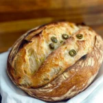 Jalapeño Cheddar Sourdough 10 Freshly baked jalapeño cheddar sourdough bread with crispy crust and melted cheese, perfect for sandwiches or snacking.