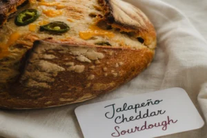 Jalapeño Cheddar Sourdough Freshly baked jalapeño cheddar sourdough bread with crispy crust and melted cheese, perfect for sandwiches or snacking.