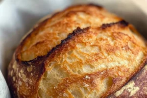 Artisan sourdough bread loaded with melted cheddar, mozzarella, and parmesan, with a golden crust and airy interior.