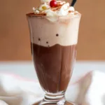 Chocolate Italian Cream Soda 8 Rich and creamy chocolate Italian cream soda topped with whipped cream and chocolate shavings in a tall glass.