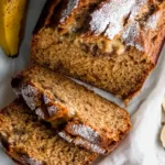 Gluten‑free Sourdough Banana Bread 8 Homemade gluten-free sourdough banana bread with a golden-brown crust, sliced open to reveal a moist, nutty interior.