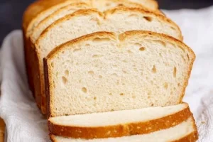 Golden, crusty gluten-free sourdough bread with airy texture, perfect for those seeking delicious, wheat-free baked goods.