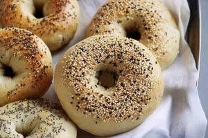 Sourdough Discard Bagels Golden-brown sourdough discard bagels with a chewy texture and slightly tangy flavor, sprinkled with sesame seeds and poppy seeds.