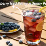 Refreshing glass of blueberry iced tea with lemon and blueberries