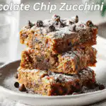 Chocolate Chip Zucchini Bars arranged beautifully under warm natural lighting