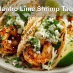 Cilantro Lime Shrimp Tacos with Creamy Slaw - Fresh & Zesty! 4 Cilantro lime shrimp tacos with creamy slaw on a clean white setup.