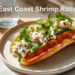 East Coast Shrimp Roll in a golden-brown bun with creamy herb dressing.