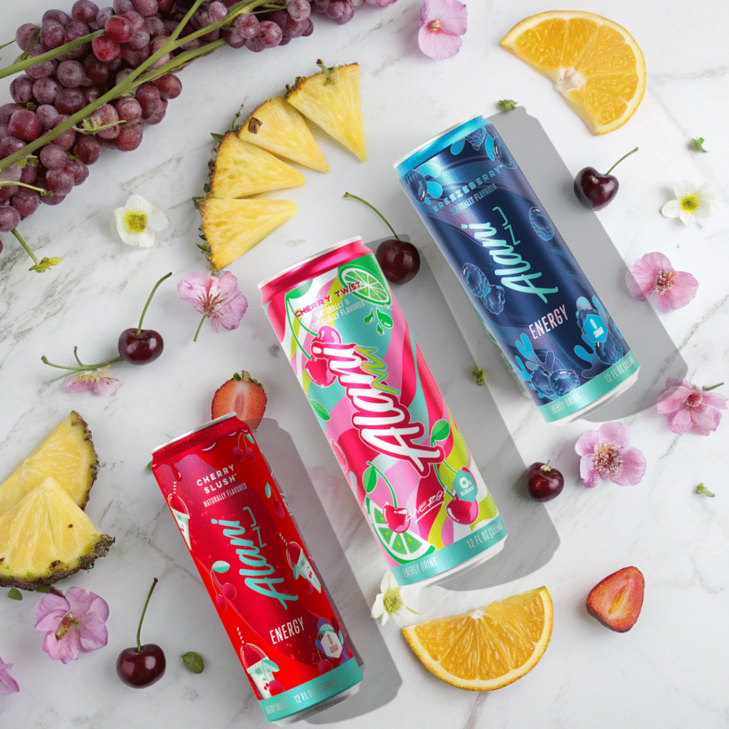 Alani Energy Drink Review: Is It Really Worth the Hype? 1 Five Alani Energy Drink cans with sliced fruits on a marble counter