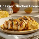 Air Fryer Chicken Breast on plate with golden chicken pieces lemon balsamic glaze
