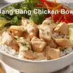 Bang Bang Chicken Bowl with tender-cooked chicken pieces rice cauliflower rice vegetables zesty creamy sauce lime