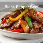 Black Pepper Beef dish with colorful peppers and glass of water