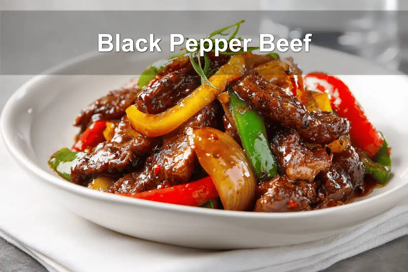 Black Pepper Beef dish with colorful peppers and glass of water