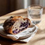 Blueberry Sourdough Bread Recipe: Bursting with Flavor 2 Plated slice of blueberry sourdough bread with natural lighting