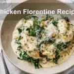 Chicken Florentine Recipe finished dish on white cloth with clear glass of water warm natural light