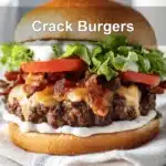 Loaded Crack Burgers featuring juicy beef patty, cheese, bacon, and sauce on a clean plate.