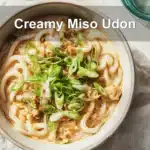 Bowl of Creamy Miso Udon with green onions in warm natural light