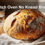 Artisan Dutch oven no-knead bread on white cloth, warm tones, clean setup, natural light.