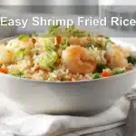 Easy Shrimp Fried Rice plated on white napkin with glass of water warm natural light
