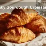 Flaky Sourdough Croissants on white napkin with water, clean and warm setup