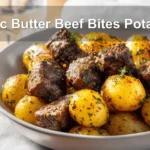 Garlic Butter Beef Bites Potatoes plated with roasted baby potatoes and garlic butter glaze