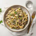 Hamburger Stroganoff elegantly served with a creamy sauce over egg noodles, professional yet approachable presentation.