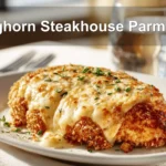 Longhorn Steakhouse Parmesan Chicken on a white napkin with water near it.