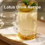 Lotus Drink Recipe in a clear glass with vibrant colors and fresh garnish