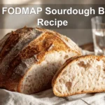 Low FODMAP Sourdough Bread Recipe finished loaf on white napkin and glass of water