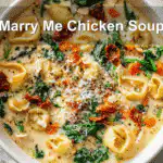 Marry Me Chicken Soup in a white bowl, warm and inviting with vibrant ingredients.