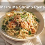 Marry Me Shrimp Pasta plated with creamy sauce, herbs, and cheese on a white napkin