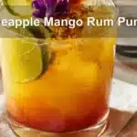 Pineapple Mango Rum Punch in a vibrant tropical setup with garnishes