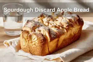 Sourdough Discard Apple Pull Apart Bread | Easy & Delicious Treat Sourdough Discard Apple Bread with cinnamon, apples, and powdered sugar, warm golden tones.