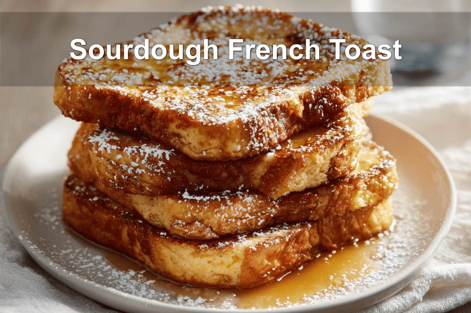 Sourdough French toast drizzled with syrup, shot in warm lighting with modern, minimalist styling.