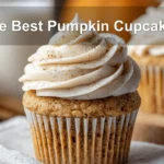 The Best Pumpkin Cupcakes presented with cream cheese frosting in a warm fall-inspired scene