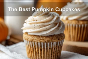 The Best Pumpkin Cupcakes presented with cream cheese frosting in a warm fall-inspired scene