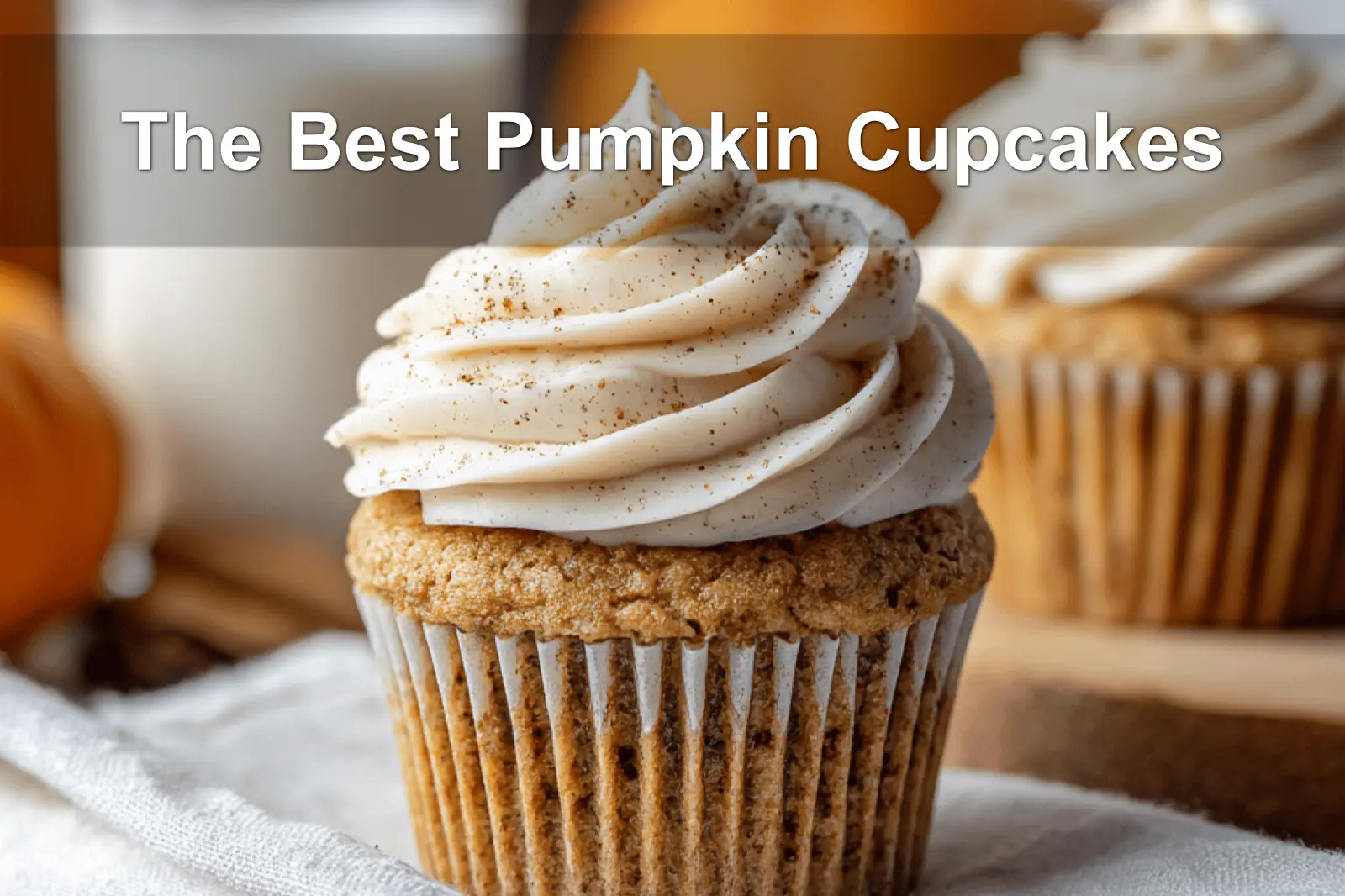 The Best Pumpkin Cupcakes presented with cream cheese frosting in a warm fall-inspired scene