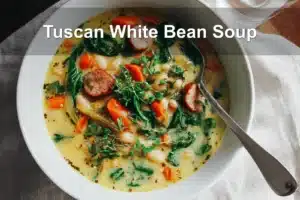 Tuscan White Bean Soup in a white bowl under warm natural light.