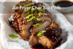 Air Fryer Char Siu Pork sliced glazed on white napkin with clear glass of water