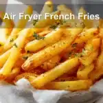 Air Fryer French Fries: Simple Tips for Delicious Snacks 6 Crispy Air Fryer French Fries on white napkin with clear water glass and warm tones