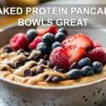 BAKED PROTEIN PANCAKE BOWLS GREAT finished bowl with berries peanut butter chocolate chips and syrup