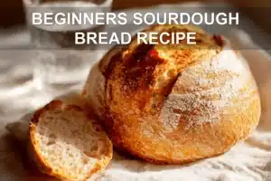 BEGINNERS SOURDOUGH BREAD RECIPE warm crusted scored loaf on white cloth with water