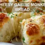 CHEESY GARLIC MONKEY BREAD golden pull apart rolls with melted cheese and fresh herbs