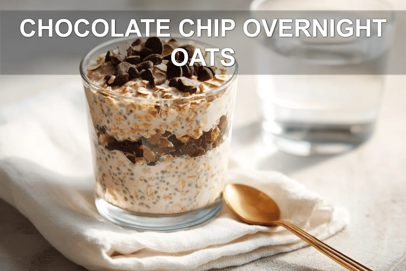 CHOCOLATE CHIP OVERNIGHT OATS creamy jar topped with vegan chips in warm natural light