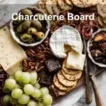 Charcuterie Board with brie prosciutto grapes figs crackers on warm styled table