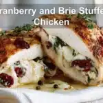 Cranberry and Brie Stuffed Chicken warm plated close up with thyme and spinach for blog header