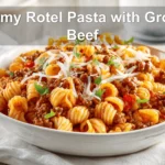 Creamy Rotel Pasta with Ground Beef plated with melted cheese and fresh herbs