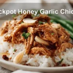 Crockpot Honey Garlic Chicken plated with rice green beans and sticky honey garlic glaze