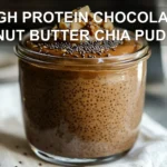 HIGH PROTEIN CHOCOLATE PEANUT BUTTER CHIA PUDDING creamy layered pudding in glass jar warm tones
